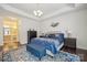 Bright main bedroom with tray ceilings, lamps, and coordinated decor at 16112 Lakeside Loop Ln, Cornelius, NC 28031