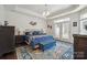 Spacious main bedroom with tray ceiling, patterned rug, and French doors at 16112 Lakeside Loop Ln, Cornelius, NC 28031