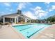 Community pool with lounge chairs and umbrellas, perfect for relaxation at 16112 Lakeside Loop Ln, Cornelius, NC 28031