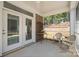 Screened-in porch with neutral-colored decor, offering a comfortable outdoor living space at 16112 Lakeside Loop Ln, Cornelius, NC 28031