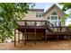 The back of the house shows a large deck, with supporting posts and the yard has mulch at 1654 Scotch Pine Ln, Fort Mill, SC 29708