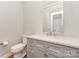 Bathroom with gray vanity, marble countertop, and modern fixtures at 1654 Scotch Pine Ln, Fort Mill, SC 29708