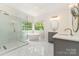 This luxurious bathroom features a glass shower, soaking tub, and double vanity with marble countertops at 1654 Scotch Pine Ln, Fort Mill, SC 29708