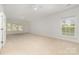 Spacious bedroom with neutral carpeting, ceiling fan, and large windows letting in natural light at 1654 Scotch Pine Ln, Fort Mill, SC 29708