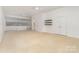 Bright bedroom features neutral carpet, built-in shelving, and a view to the upper mezzanine at 1654 Scotch Pine Ln, Fort Mill, SC 29708
