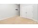 Bedroom showcasing neutral carpet, double door closet, and a doorway leading to another room at 1654 Scotch Pine Ln, Fort Mill, SC 29708