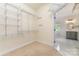 Large walk-in closet with adjustable metal shelving and doorway into the Primary bathroom at 1654 Scotch Pine Ln, Fort Mill, SC 29708