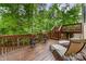 Spacious wooden deck with comfortable lounge chairs and stairs, perfect for relaxation and enjoying the outdoors at 1654 Scotch Pine Ln, Fort Mill, SC 29708