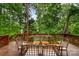 Outdoor deck with dining table and chairs, surrounded by lush trees and greenery at 1654 Scotch Pine Ln, Fort Mill, SC 29708