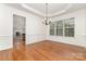 Formal dining room featuring hardwood floors, wainscoting, and backyard views at 1654 Scotch Pine Ln, Fort Mill, SC 29708