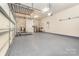 Spacious garage with epoxy flooring, ample storage racks and space for multiple vehicles at 1654 Scotch Pine Ln, Fort Mill, SC 29708