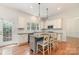 Bright eat-in kitchen featuring stainless steel appliances, shaker cabinets, and a gray island with granite countertops at 1654 Scotch Pine Ln, Fort Mill, SC 29708