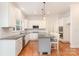 Bright kitchen featuring stainless steel appliances, shaker cabinets, and a gray island with granite countertops at 1654 Scotch Pine Ln, Fort Mill, SC 29708