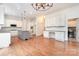 Gourmet kitchen featuring stainless steel appliances, a gray island with granite countertops, and hardwood floors at 1654 Scotch Pine Ln, Fort Mill, SC 29708