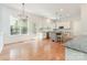 Eat-in kitchen featuring stainless steel appliances, island with granite countertops, and hardwood floors at 1654 Scotch Pine Ln, Fort Mill, SC 29708