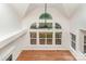 Living room featuring hardwood floors, large arched windows, high vaulted ceilings, and a ceiling fan at 1654 Scotch Pine Ln, Fort Mill, SC 29708
