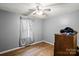 Cozy bedroom featuring hardwood floors, neutral walls, and a ceiling fan with lighting at 205 Pinehurst Dr, Kings Mountain, NC 28086