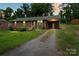 Charming single-story brick home featuring a driveway and mature trees at 205 Pinehurst Dr, Kings Mountain, NC 28086