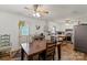 Eat-in kitchen with stainless refrigerator and wooden table and dining set at 205 Pinehurst Dr, Kings Mountain, NC 28086