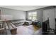 Cozy living room with hardwood floors and a large corner sofa at 205 Pinehurst Dr, Kings Mountain, NC 28086