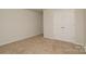 Bright bedroom featuring neutral carpet and a double door closet for storage at 2210 Transatlantic Ave, Charlotte, NC 28215