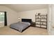 Spacious bedroom features neutral carpet, a comfortable queen bed, and shelving for ample storage at 2210 Transatlantic Ave, Charlotte, NC 28215