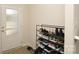 Cozy entryway featuring a shoe rack filled with various pairs of shoes and a glass paneled door at 2210 Transatlantic Ave, Charlotte, NC 28215