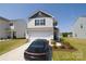 Charming two-story home with a manicured lawn, a car, and an attached two-car garage at 2210 Transatlantic Ave, Charlotte, NC 28215