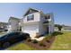 Charming two-story home with a well-kept lawn and a black car in the driveway at 2210 Transatlantic Ave, Charlotte, NC 28215