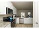 Modern kitchen with stainless steel appliances, white cabinets, and granite countertops at 2210 Transatlantic Ave, Charlotte, NC 28215