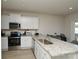 Modern kitchen with stainless steel appliances, white cabinets, and a view into the dining area at 2210 Transatlantic Ave, Charlotte, NC 28215