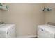 Clean laundry room with modern washer and dryer units and shelving for storage at 2210 Transatlantic Ave, Charlotte, NC 28215
