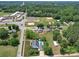 Stunning aerial view showcases the home, pool, ball fields, and nearby school at 225 N Main St, Mount Pleasant, NC 28124