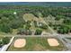 Beautiful aerial shot showcasing the home, pool, and nearby ball fields and water tower at 225 N Main St, Mount Pleasant, NC 28124