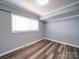 Basement with wood flooring, window, and neutral colored walls at 225 N Main St, Mount Pleasant, NC 28124