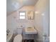 Compact bathroom featuring a toilet, sink, and tub at 225 N Main St, Mount Pleasant, NC 28124