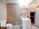 A cozy bathroom features a vintage vanity with white cabinets and neutral paint at 225 N Main St, Mount Pleasant, NC 28124