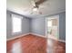Bedroom with hardwood floors, ceiling fan and access to an ensuite bathroom at 225 N Main St, Mount Pleasant, NC 28124
