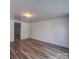 Spacious bedroom features modern floors, fresh paint, and ample natural light at 225 N Main St, Mount Pleasant, NC 28124
