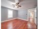 This bedroom features hardwood floors and neutral walls with access to ensuite bathroom at 225 N Main St, Mount Pleasant, NC 28124