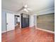 Bedroom features hardwood floors, ceiling fan and access to other rooms at 225 N Main St, Mount Pleasant, NC 28124