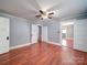 Spacious bedroom featuring wood flooring, neutral walls, and a modern ceiling fan at 225 N Main St, Mount Pleasant, NC 28124