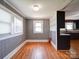 Dining room featuring a large window, wood floors, and gray walls at 225 N Main St, Mount Pleasant, NC 28124