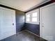 Entryway with three windows, wood-look floors, and access to other areas of the home at 225 N Main St, Mount Pleasant, NC 28124