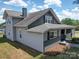 Angled view of the home showing the light and dark gray exterior and roof at 225 N Main St, Mount Pleasant, NC 28124