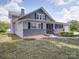 Angled view of the light and dark gray home on a beautiful sunny day at 225 N Main St, Mount Pleasant, NC 28124