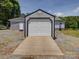 View of garage with wood ramp and a matching storage shed behind it at 225 N Main St, Mount Pleasant, NC 28124