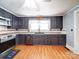This functional kitchen features dark cabinets, ample counter space, and modern appliances at 225 N Main St, Mount Pleasant, NC 28124
