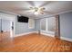 The living room has wood floors, a ceiling fan, and large windows that provide plenty of natural light at 225 N Main St, Mount Pleasant, NC 28124