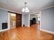 An open-concept living room has hardwood floors, classic trim, and a view into the bathroom at 225 N Main St, Mount Pleasant, NC 28124